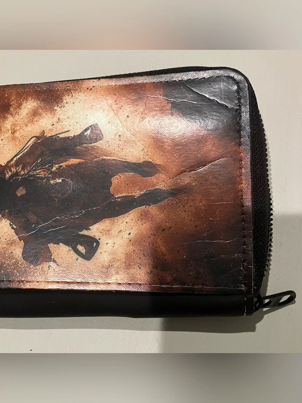 Western-themed zip-around wallet cowboy riding horse sunset